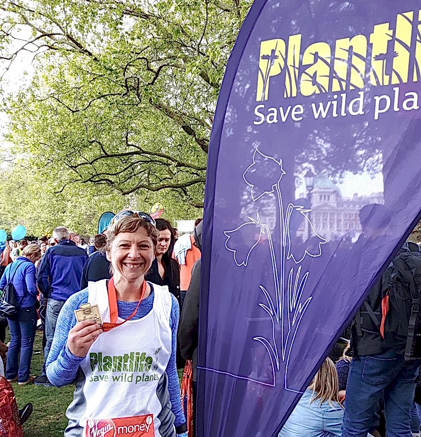 Lady in Plantlife Running Vest with Medal.