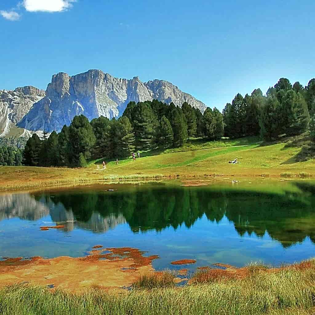 Lake in foreground with mountain range in background